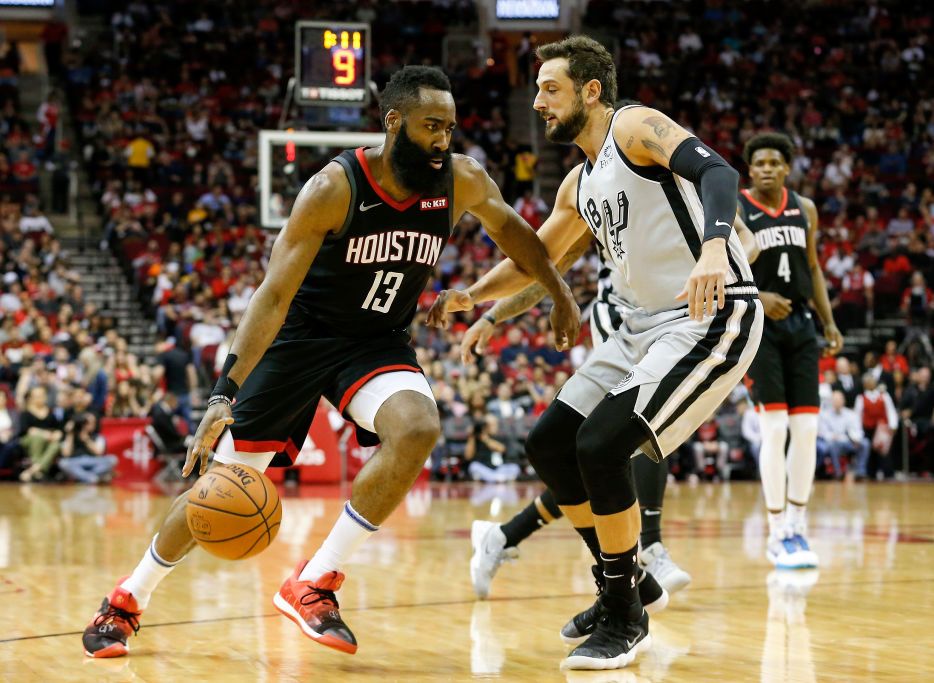 James Harden đã chơi cho Houston Rockets, Brooklyn Nets và Philadelphia 76ers james harden dribbling a basketball in front of a defender during an nba game