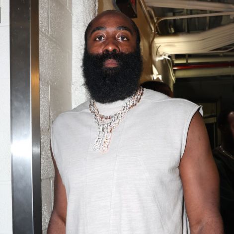 James Harden vào tháng 8 năm 2023 james harden looks at the camera with a straight face, he wears a white sleeveless shirt and a large multistrand diamond necklace